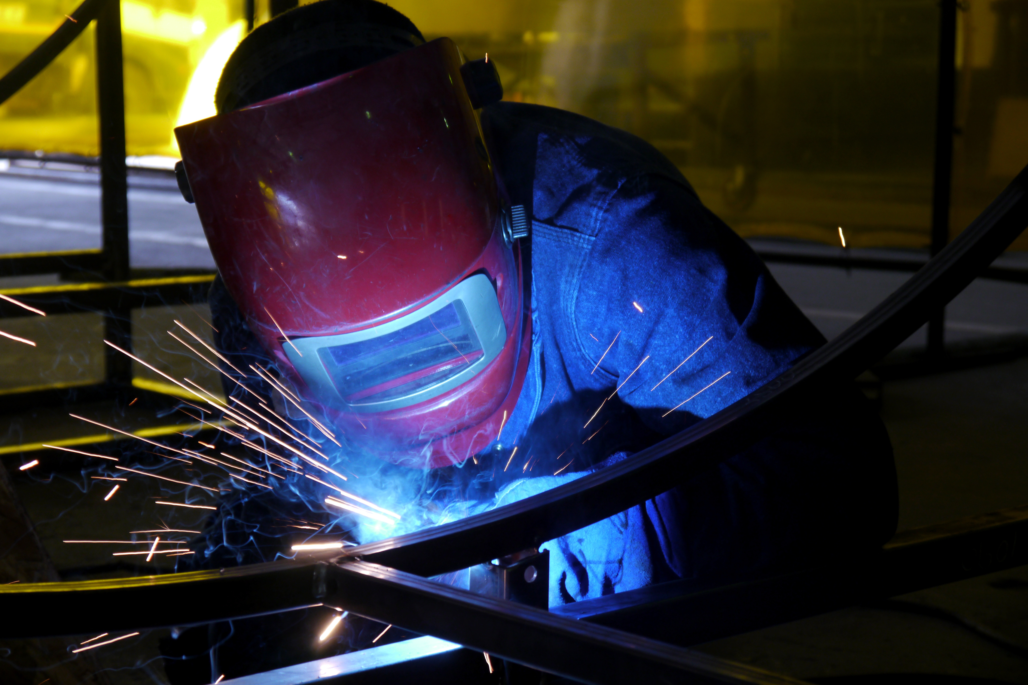 man welding steel